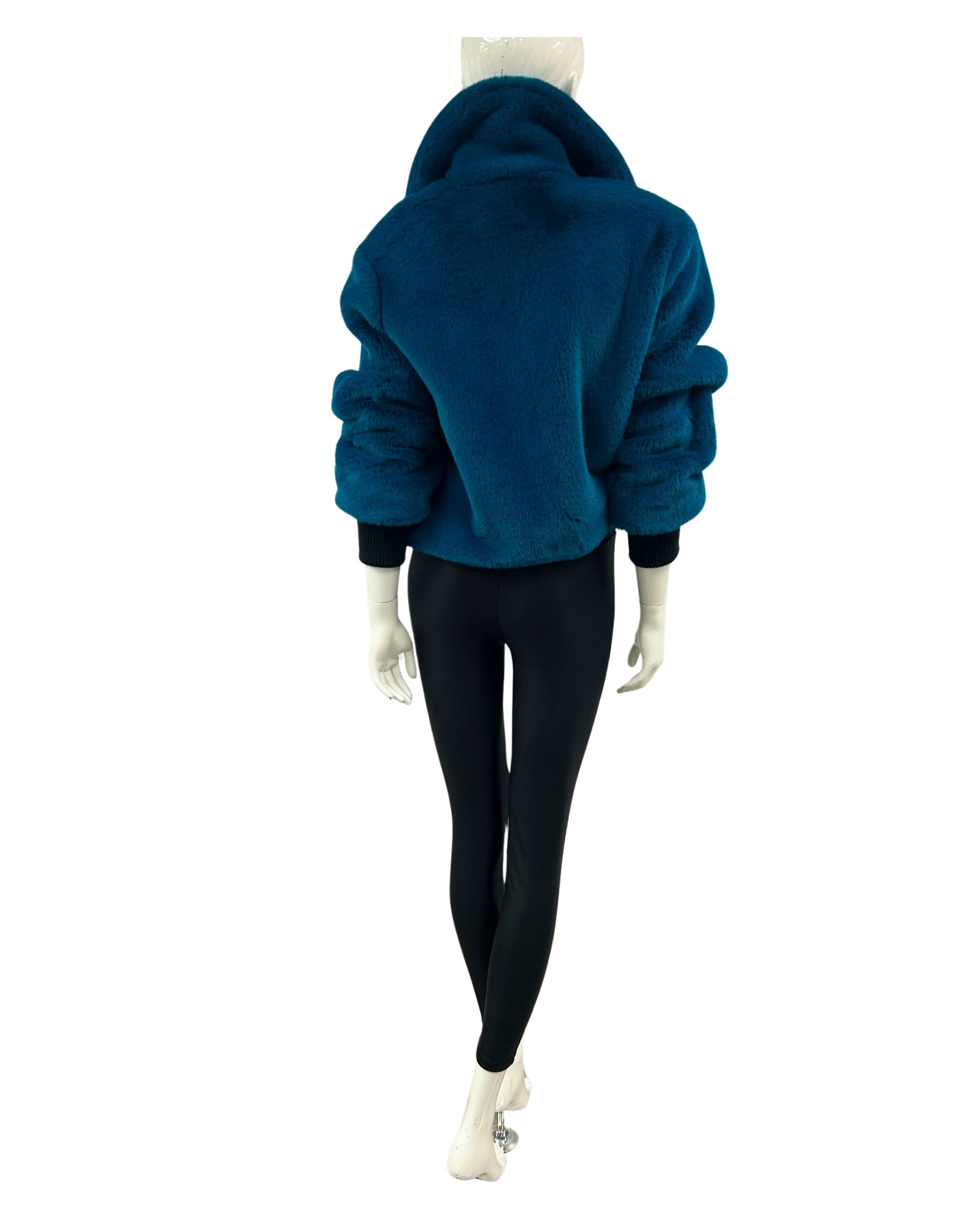 Mannequin wearing a blue faux fur jacket and black leggings on a white background