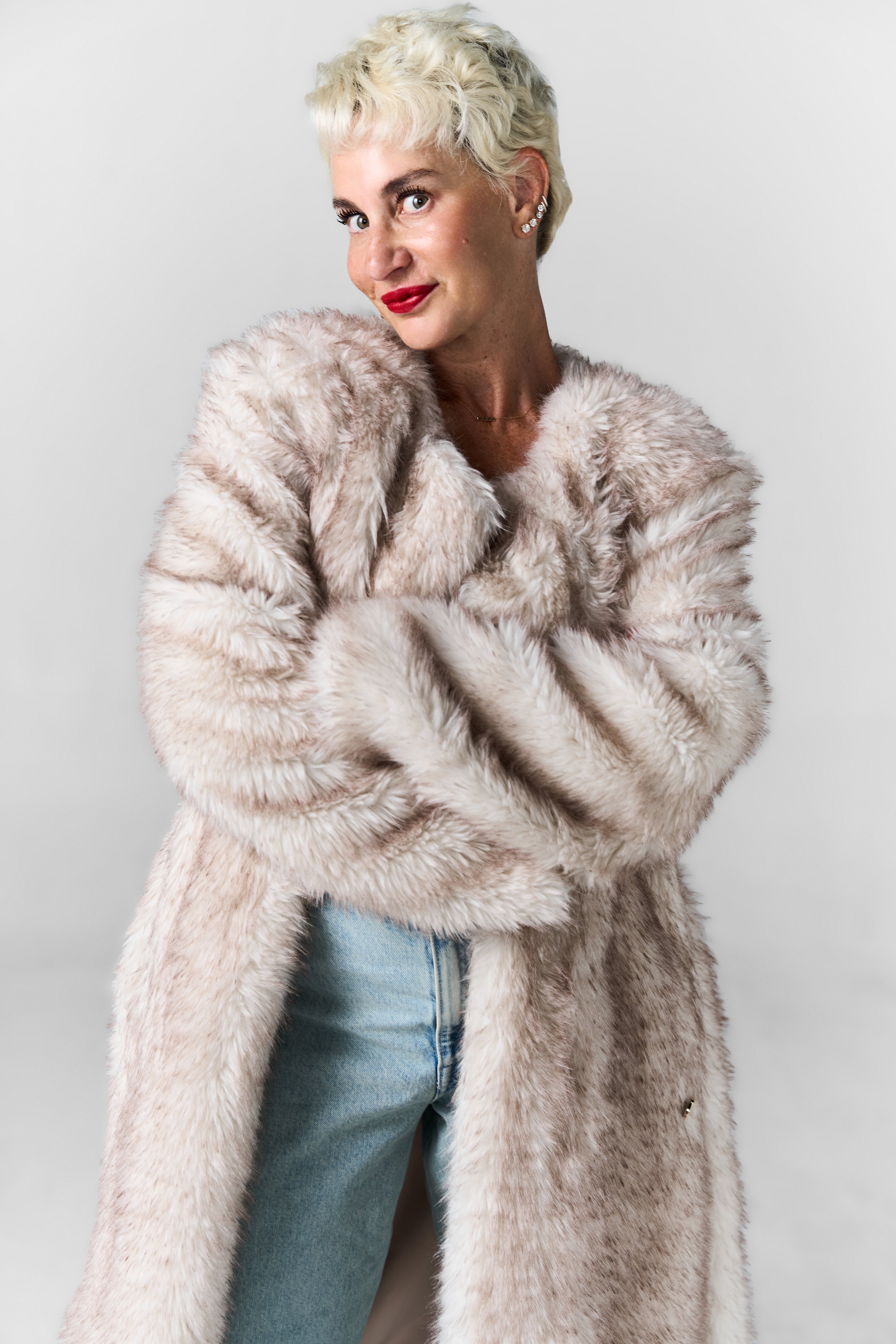 FREED founder, Marissa Freed, posing in a FREED faux fur coat.