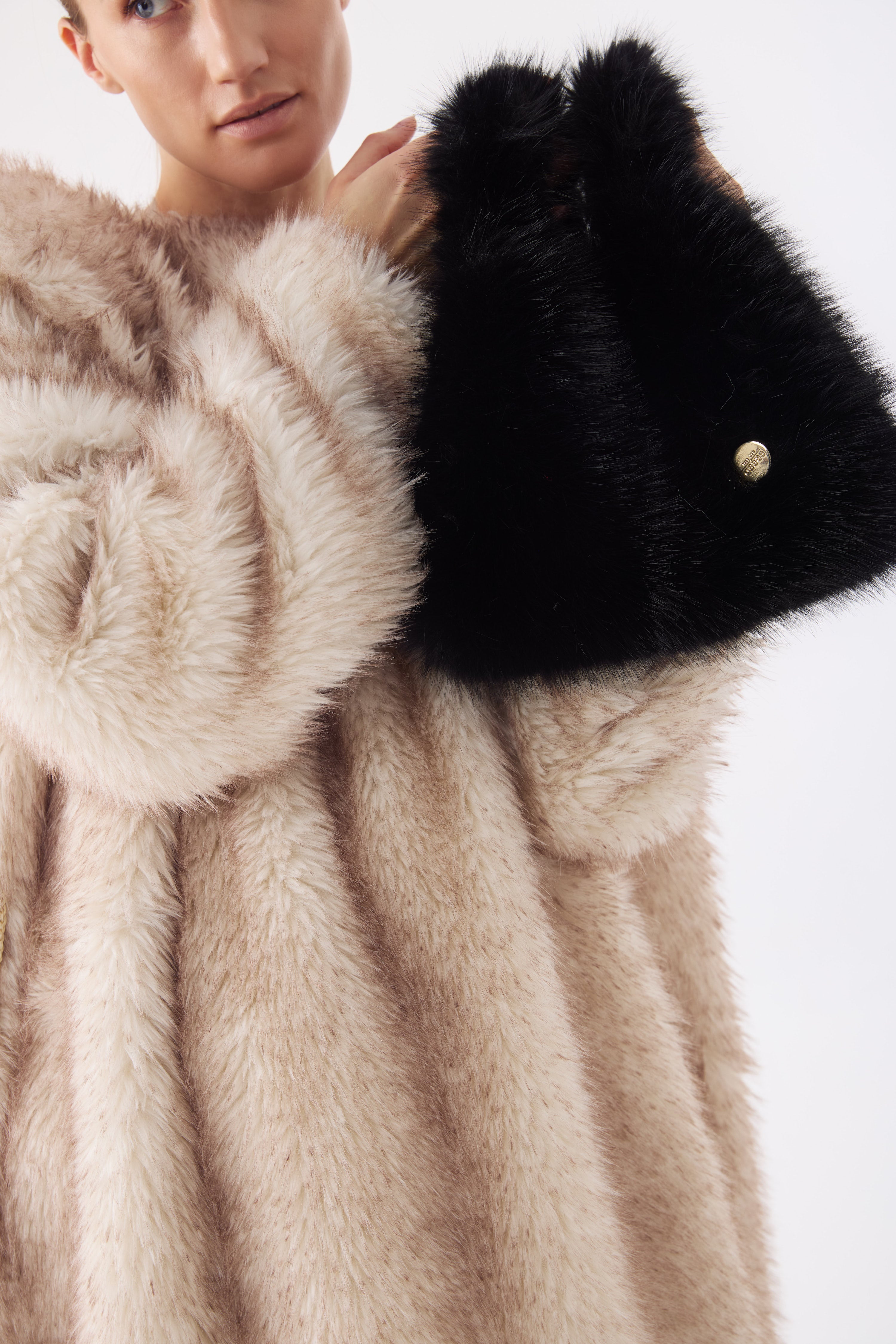 Detail shot — close-up of the Tiny Tote in Ink Black, emphasizing the fine texture and craftsmanship of the faux fur.

